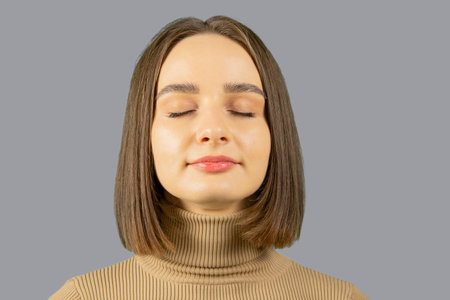 Portrait of a woman with closed eyes. Mindfulness and calmness concept.