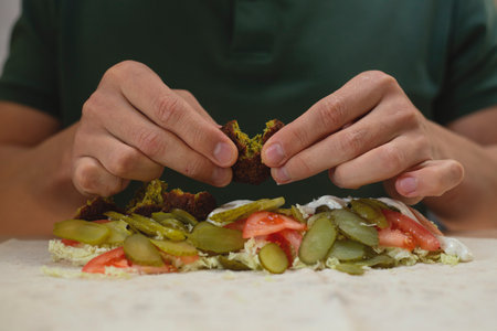 Man cooking homemade falafel meal.の写真素材