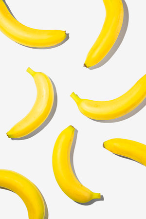 Creative flat lay yellow bananas on white background.の写真素材