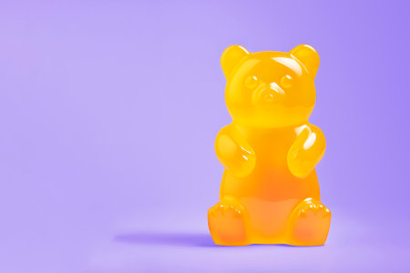 Large yellow vitamin gummy bear on purple background with copy space. AI generatedの素材