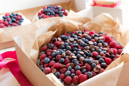Big carrot pie with chocolate cream, blueberry, raspberry and milk chocolate drops. And two small zephyr cakes.の写真素材