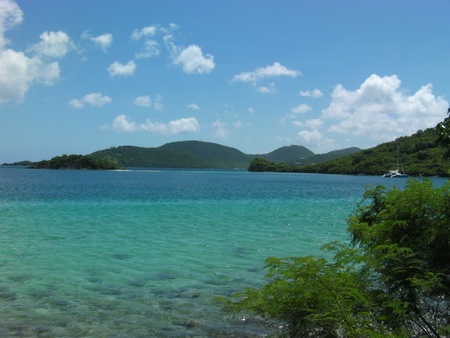 Clear Ocean Water with Mountains and Cloudy Skyの写真素材