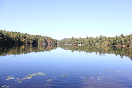 Fall Foliage around Vermont Lake with Blue Skyの写真素材