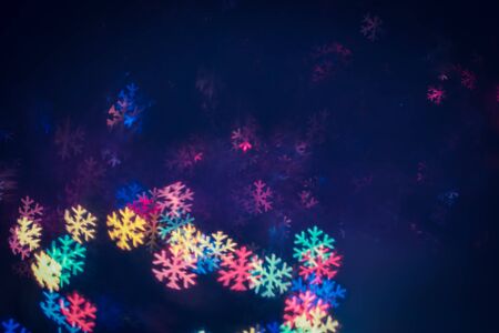 Festive Lights Blurred Photo in the Shape of Snowflake. Abstract Christmas and New Year Backgroundの写真素材