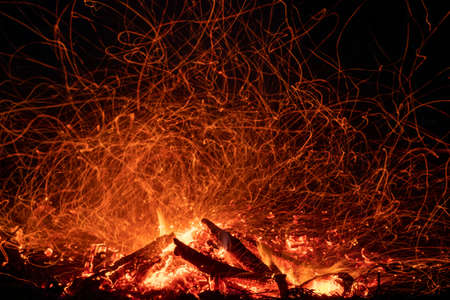 Bonfire shot at night at long exposure with randomly flying sparksの写真素材