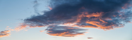 Captivating clouds at sunset, painted with vibrant hues, perfect for evocative and atmospheric visualsの写真素材
