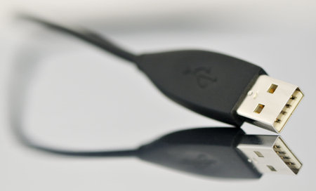 USB connector on reflective surface, selective focus, close-up