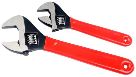 Pair of adjustable steel spanners with red plastic handle isolated on whiteの写真素材