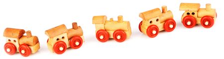Wooden toy railway steam-engines with red wheels isolated on whiteの写真素材