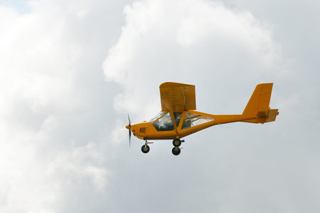 Flying private propeller-driven airplane over cloud sky