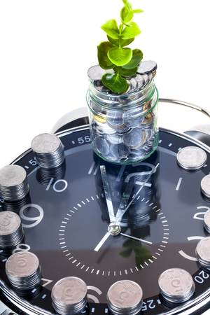 coins with plant and clock, isolated on white background.の写真素材