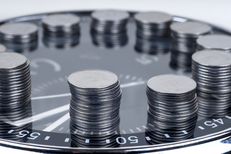 coins with plant and clock, isolated on white background.の写真素材