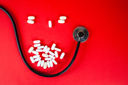 Pills ,tablets and stethoscope on white backgroundの写真素材
