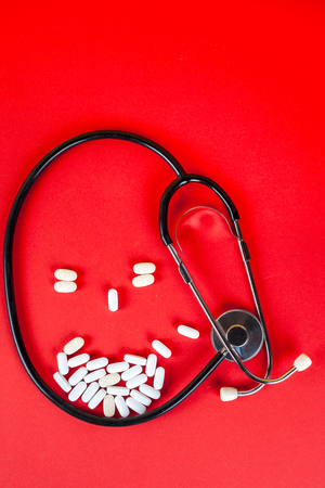 Pills ,tablets and stethoscope on white backgroundの写真素材