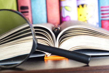 composition with open book and magnifying glass. Back to school, copy space. Education background.の写真素材