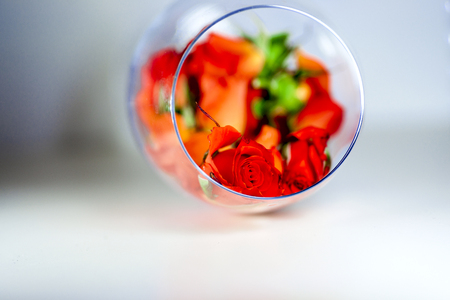 Glass vase filled with red rose petals. Aromatherapy concept.の写真素材