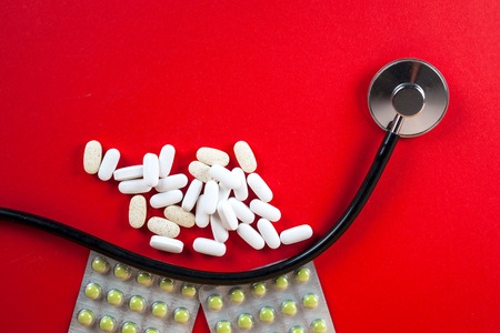 Pills ,tablets and stethoscope on white backgroundの写真素材
