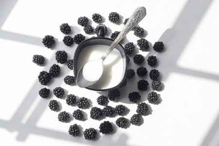 Various fresh summer berries, cup of coffee on natural background.の写真素材