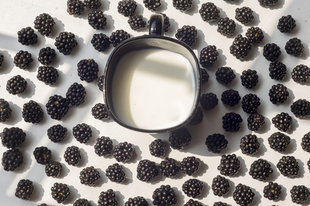 Various fresh summer berries, cup of coffee on natural background.の写真素材