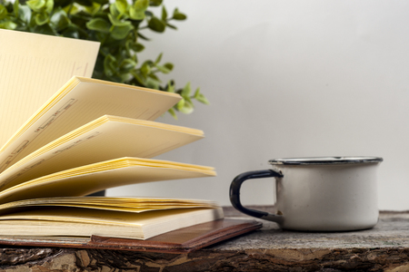 Old vintage books, cup of tea, cake and keys on rustic wooden tableの写真素材