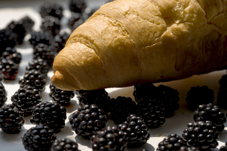 Fresh croissant and blackberries on natural white background,の写真素材