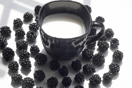Various fresh summer berries, cup of coffee on natural background.の写真素材