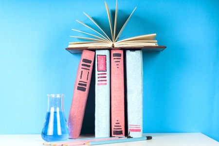 Open book, hardback books on bright colorful background.の写真素材