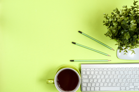 Office desk table with computer, supplies and coffee cup. Top view. copy spaceの写真素材