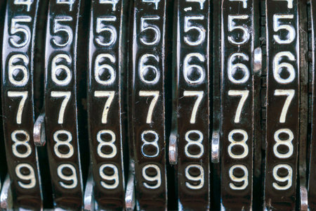 Old rusty retro calculator black standing on a wooden table