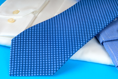 Stack of blue and white shirt closeup on a light background.の写真素材
