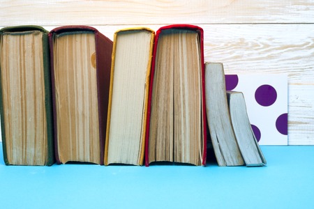 Open book, hardback books on bright colorful background.の写真素材