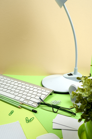 Office black desk table with white computer, supplies.の写真素材
