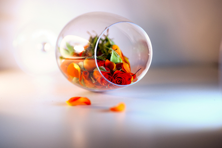 Glass vase filled with red rose petals. Aromatherapy concept.の写真素材