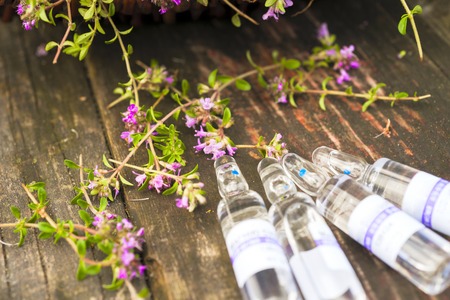 Alternative Medicine.Thyme and medical ampoules. Essential oilsの写真素材