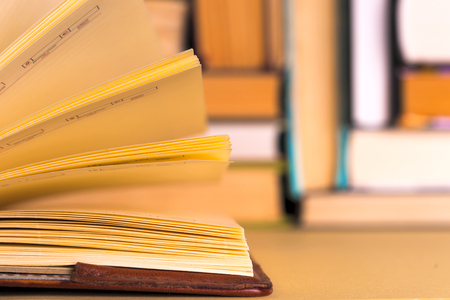 Open book, hardback books on bright colorful background.の写真素材