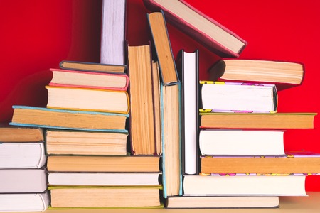 Open book, hardback books on bright colorful background.の写真素材