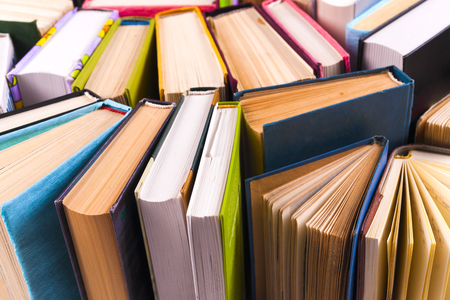 Open book, hardback books on bright colorful background.の写真素材
