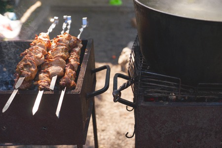 Marinated shashlik preparing on a barbecue grill over charcoal. Shashlyk was originally made of lamb. Man cookingの写真素材