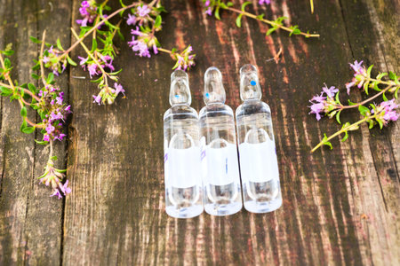 Alternative Medicine.Thyme and medical ampoules. Essential oils