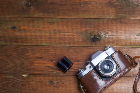 Old retro camera on vintage wooden boards abstract background. Copy space for textの写真素材