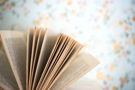 Open book, hardback books on bright colorful background.の写真素材