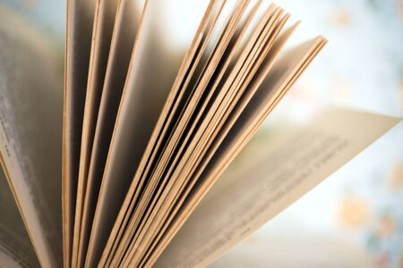 Open book, hardback books on bright colorful background.の写真素材