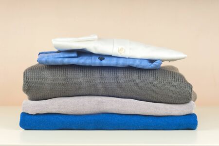 Stack of blue and white shirt closeup on a light background.の写真素材