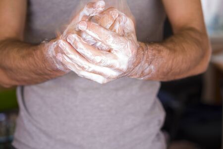Washing hands rubbing with soap man for corona virus prevention, hygiene to stop spreading coronavirusの写真素材