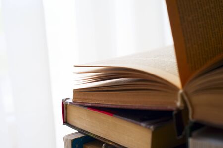 Open book, hardback books on bright colorful background. Back to school. Copy space for textの写真素材