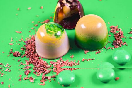 Top view of set of beautiful and delicious chocolate sweets decorated with assorted chocolate crumbsの写真素材