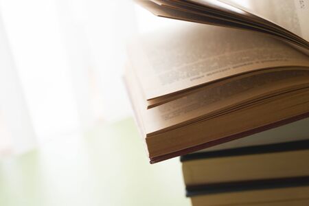 Open book, hardback books on bright colorful background.の写真素材