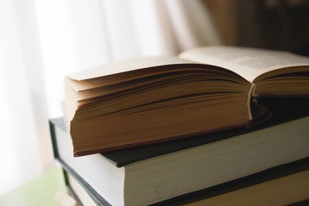 Open book, hardback books on bright colorful background.の写真素材