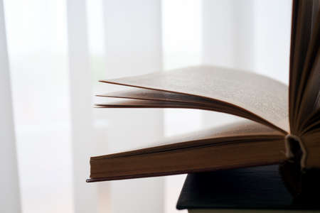 Open book, hardback books on bright colorful background.の写真素材
