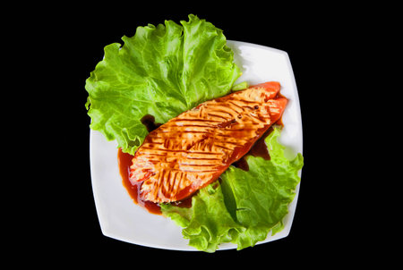 Salmon steak on black backgroundの写真素材